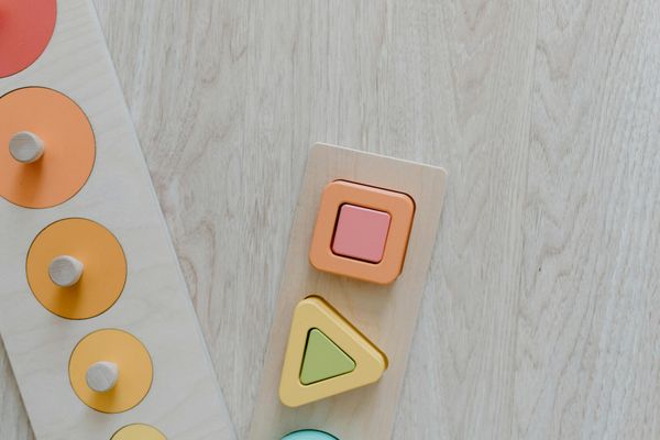 Children in a circle playing a yoga game with colorful props.