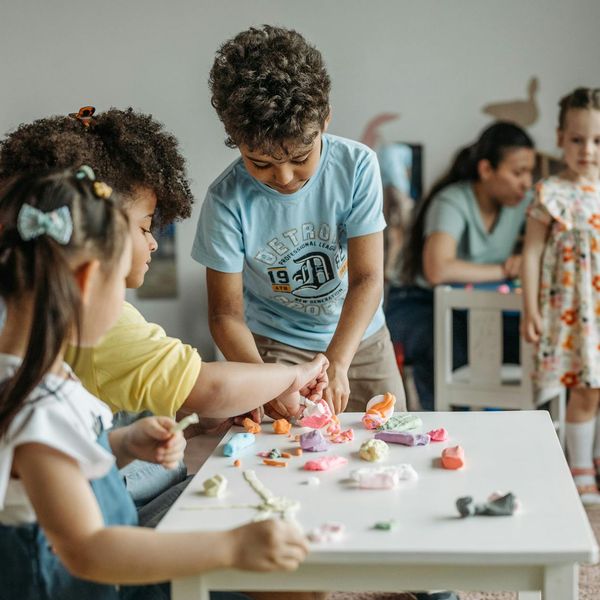 Group of diverse children smiling during a fun yoga class.